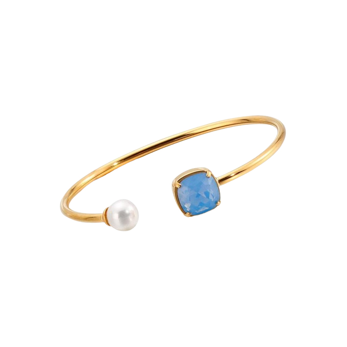 Gold open cuff bangle with a blue gemstone and pearl accent