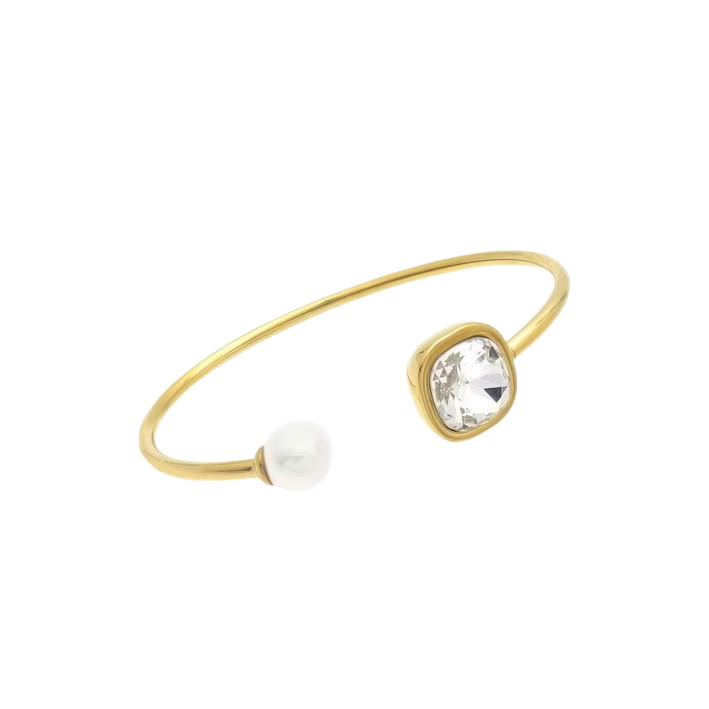 Gold-plated open bracelet featuring a pearl and a sparkling crystal accent.